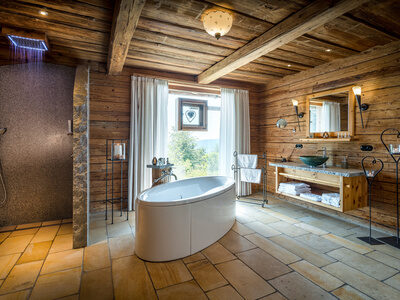 Badezimmer im Luxus Chalet Bayern mit freistehender Badewanne und Panoramafenster