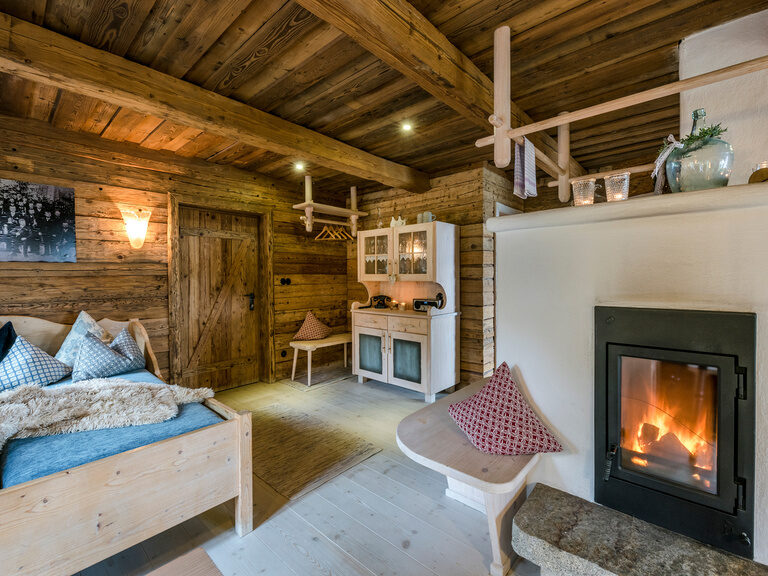 Kuscheliges Bett und Kachelofen im Luxus Chalet Bayern