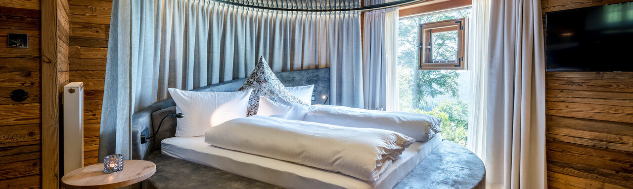Schlafzimmer mit rundem Bett im Luxus Chalet Bayern